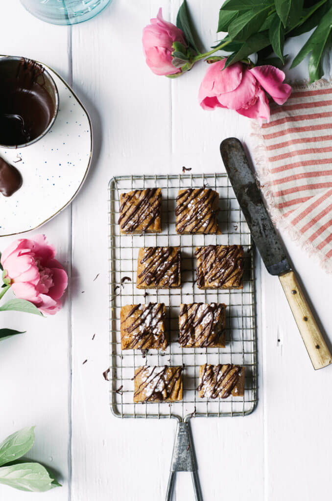 This Paleo snack cake is so incredibly moist and practically melts in your mouth. Tastefully drizzled with lushes chocolate sauce, this grain free dessert makes a perfect snack for those sweet tooth cravings.