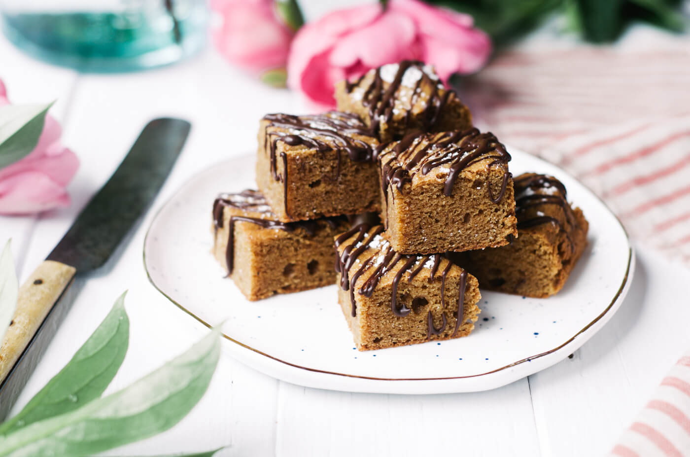 This Paleo dessert snack cake is so incredibly moist and practically melts in your mouth. Tastefully drizzled with lushes chocolate sauce, this grain free dessert makes a perfect snack for those sweet tooth cravings.