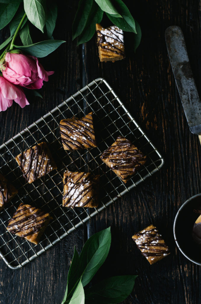 This Paleo snack cake is so incredibly moist and practically melts in your mouth. Tastefully drizzled with lushes chocolate sauce, this grain free dessert makes a perfect snack for those sweet tooth cravings.