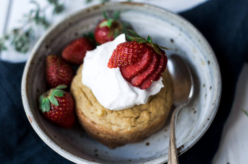 This soft grain free paleo mug muffin is made in a few minutes. Topped with lushes whipped cream and fresh strawberries, this easy to make recipe for strawberry shortcake mug muffin is a delicious time saver and makes for an easy breakfast, dessert, or snack. This recipe is sugar free and sweetened with stevia liquid.