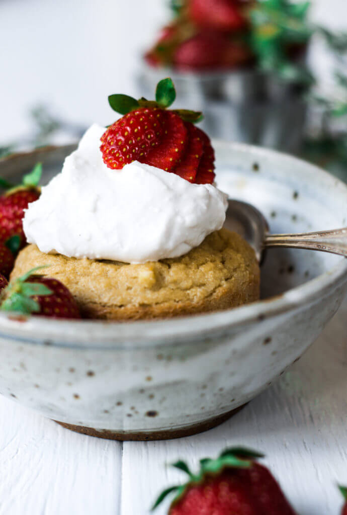 This soft grain free paleo mug muffin is made in a few minutes. Topped with lushes whipped cream and fresh strawberries, this easy to make recipe for strawberry shortcake mug muffin is a delicious time saver and makes for an easy breakfast, dessert, or snack. This recipe is sugar free and sweetened with stevia liquid.