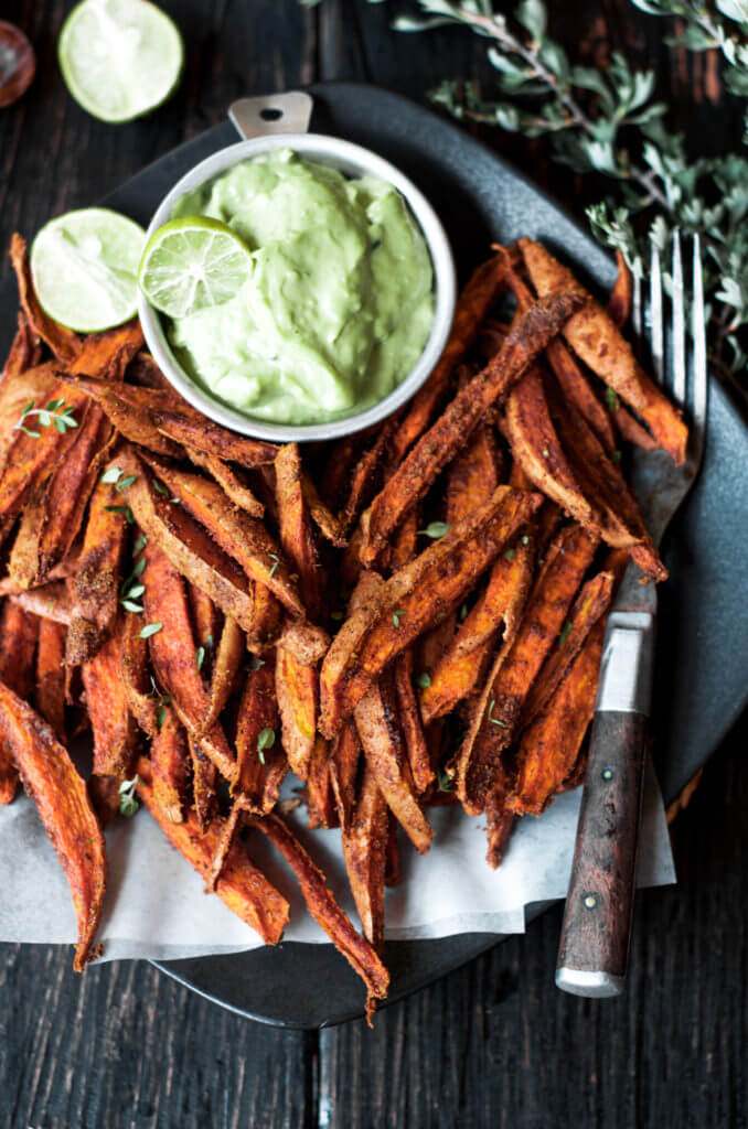 Cumin spiced sweet potato fries are paleo and gluten free. These tasty seasoned fries make the perfect healthy and delicious snack or side dish. This recipe is served with a creamy avocado garlic dipping sauce.