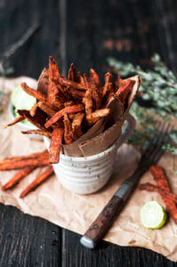 Cumin spiced sweet potato fries are paleo and gluten free. These tasty seasoned fries make the perfect healthy and delicious snack or side dish. This recipe is served with a creamy avocado garlic dipping sauce.