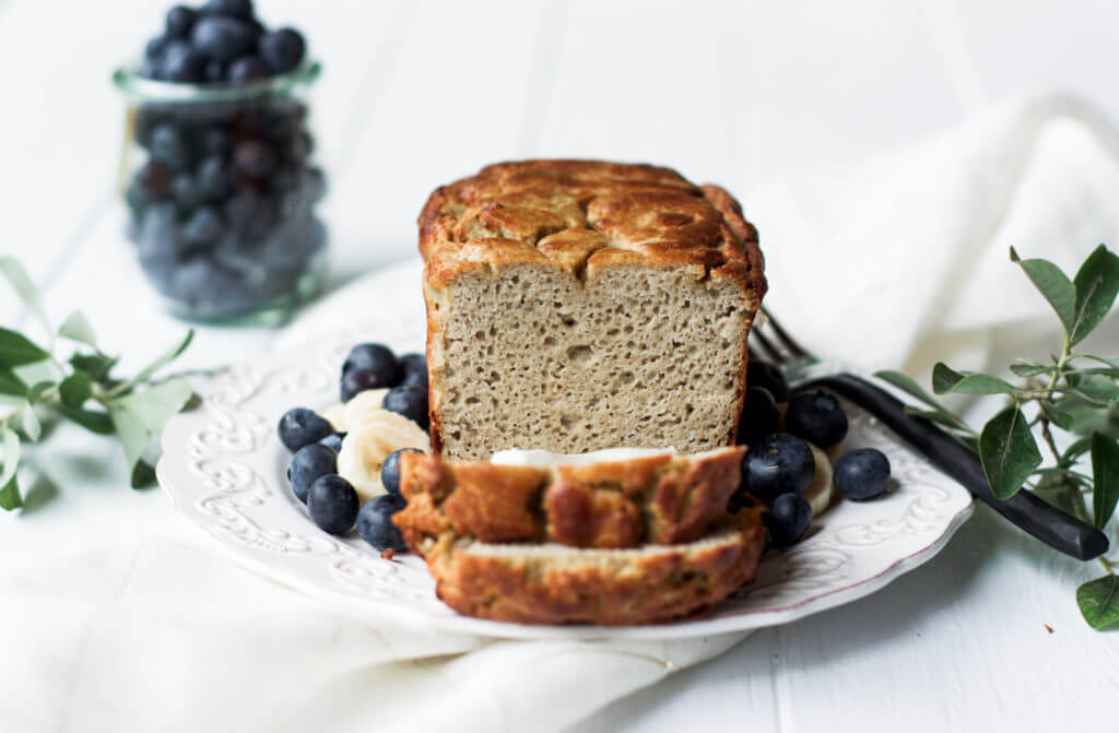 This Grain Free & Paleo Banana Bread is incredibly easy to make and it's made in a blender! Light and airy bread with a delicious crust, this banana bread only takes 5 minutes to whip up and then it's in the oven.