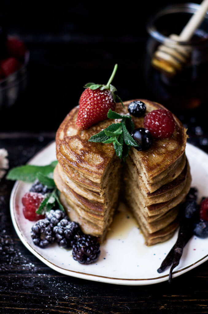 Paleo pancakes made with only four ingredients! These soft and flavorful grain free pancakes are so addictingly delicious and easy to make. The rich and tasty flavors from these pancakes are perfect paired with fresh juicy berries and a drizzle of maple syrup.