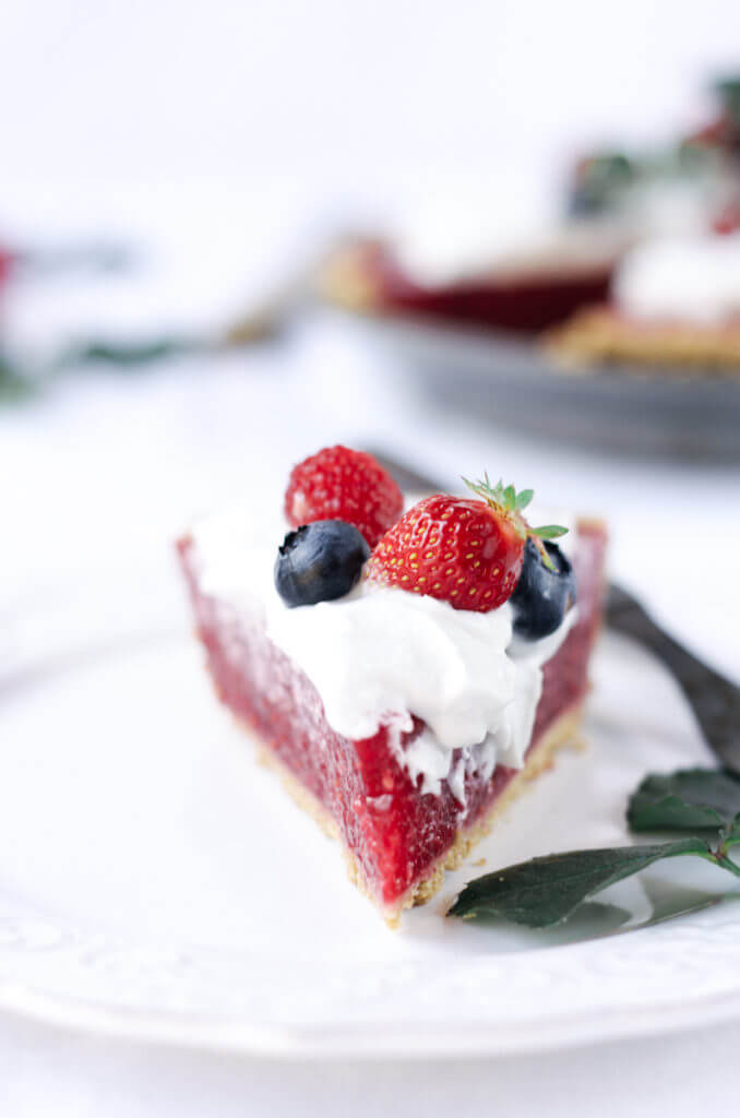 Fun, pretty, and delicious! This gluten free and dairy free pie is made with a delicious graham cracker crust. Filled with fresh raspberry filling, and topped with whipped coconut cream and berries.