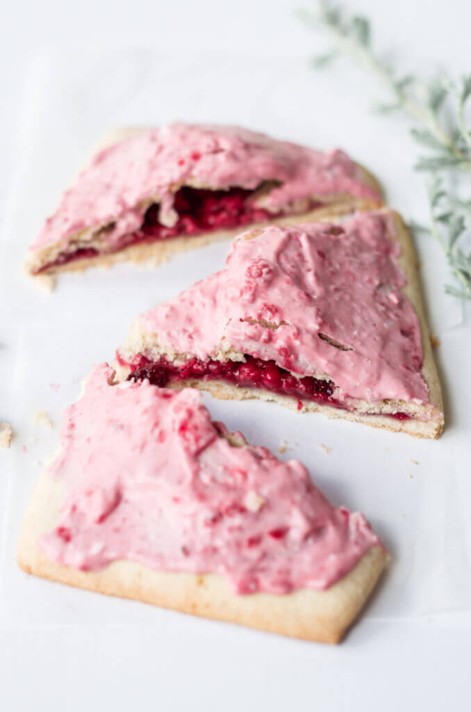 Easy to make paleo raspberry pop tarts are so full of flavor, naturally sweetened, and grain free. These delectable breakfast tarts have a delicious flaky crust (that doesn't crumble) and are filled with sweet berry filling. Gluten free and healthy!