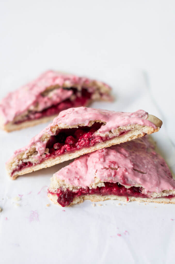 Easy to make paleo raspberry pop tarts are so full of flavor, naturally sweetened, and grain free. These delectable breakfast tarts have a delicious flaky crust (that doesn't crumble) and are filled with sweet berry filling. Gluten free and healthy!