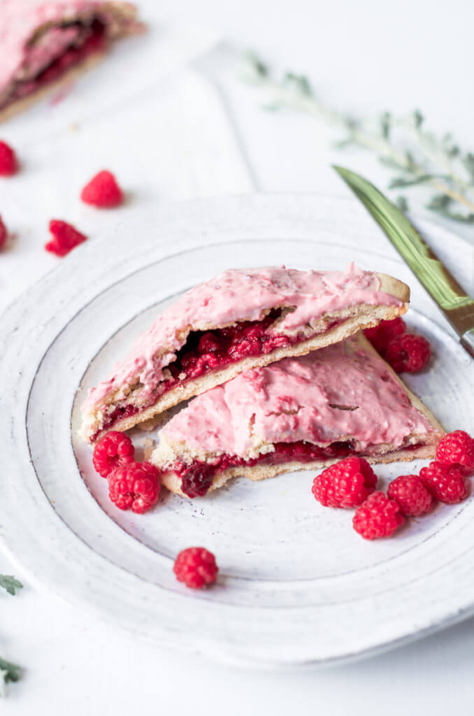 Easy to make paleo raspberry pop tarts are so full of flavor, naturally sweetened, and grain free. These delectable breakfast tarts have a delicious flaky crust (that doesn't crumble) and are filled with sweet berry filling. Gluten free and healthy!