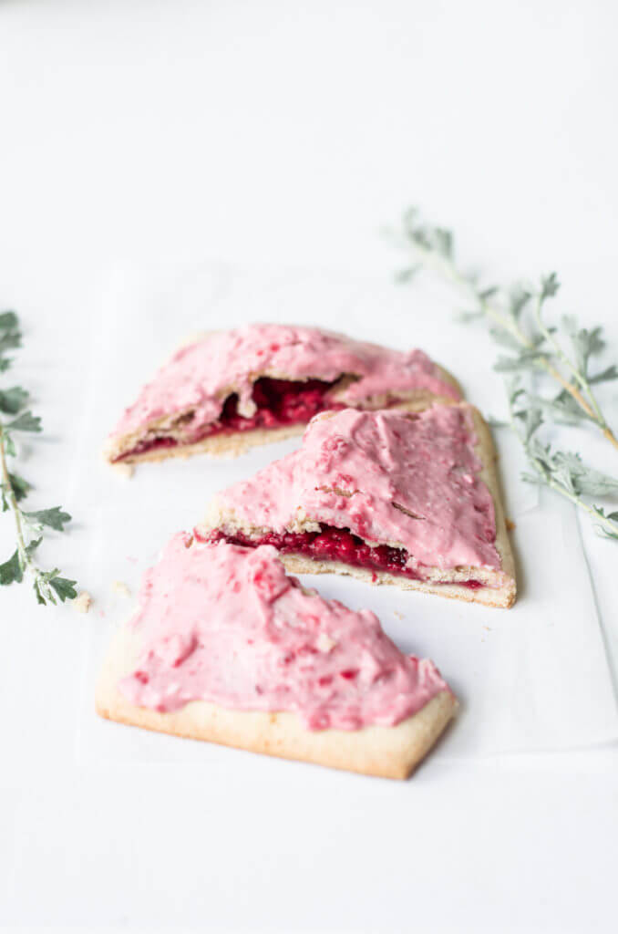 Easy to make paleo raspberry pop tarts are so full of flavor, naturally sweetened, and grain free. These delectable breakfast tarts have a delicious flaky crust (that doesn't crumble) and are filled with sweet berry filling. Gluten free and healthy!