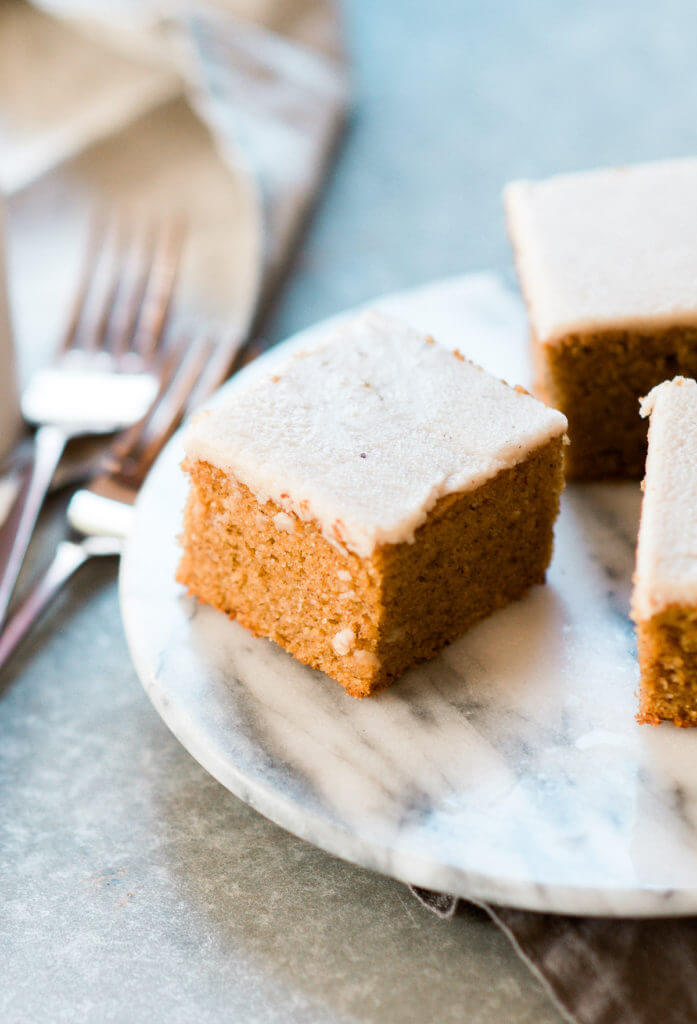 Grain free, gluten free, healthy, paleo, protein packed pumpkin cake with vegan maple frosting- no refined sugar! Soft, light, perfect for a fall dessert or healthy paleo snack. Easy Pumpkin Breakfast Cake.