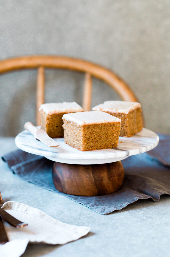 Grain free, gluten free, healthy, paleo, protein packed pumpkin cake with vegan maple frosting- no refined sugar! Soft, light, perfect for a fall dessert or healthy paleo snack. Easy Pumpkin Breakfast Cake.