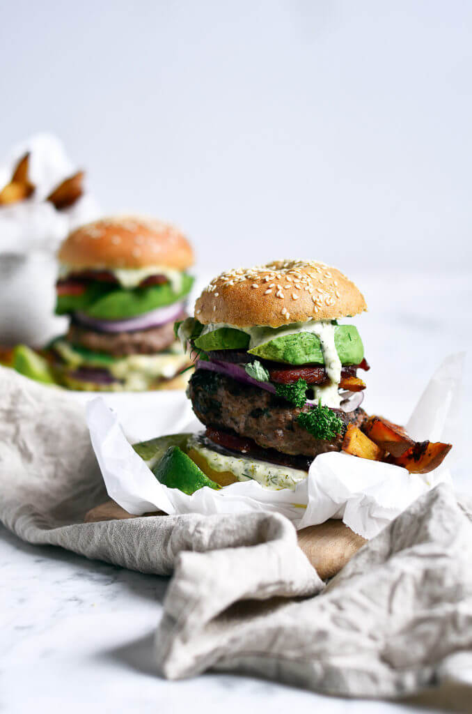 The most delicious LEGIT Paleo bacon avocado burgers! Loaded with fresh basil and garlic. Topped with a creamy white sauce and red onion. Plus, these fluffy and soft grain free buns are to die for! Check out the whole30 burger option too! Paleo burger recipe. Paleo burger patties. Paleo beef burgers. Paleo meal plan. Easy paleo dinner recipes. Easy whole30 dinner recipes. Whole30 recipes. Whole30 lunch. Whole30 meal planning. Whole30 meal prep. Healthy paleo meals. Healthy Whole30 recipes. Easy Whole30 recipes.