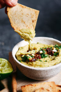 5 minute garlic lime cashew hummus is made without beans (gasp!). Made with soaked cashews, garlic, lime, parsley. Deliciously creamy, smooth, and full of flavor! Whole30 and paleo friendly. Served with paleo cassava flour pita chips! Whole30 hummus. Whole30 snacks. Paleo hummus. Paleo Snacks. easy cashew hummus dip. Hummus dip. best healthy hummus. Easy hummus recipe. Garlic lime hummus recipe.
