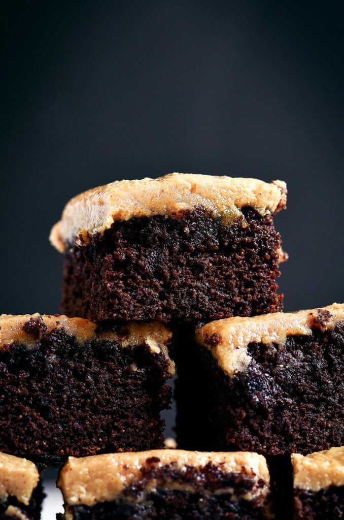 Ready for some chocolate goodness?! The best healthy paleo coconut flour brownies topped with a smooth and creamy peanut butter frosting (almond butter for paleoers). Each brownie has 16g protein! Best gluten free brownies. Best paleo brownies recipe. Fudgey paleo brownie recipe. Fudgey chocolate brownies. Healthy brownie recipe. Easy paleo brownies.