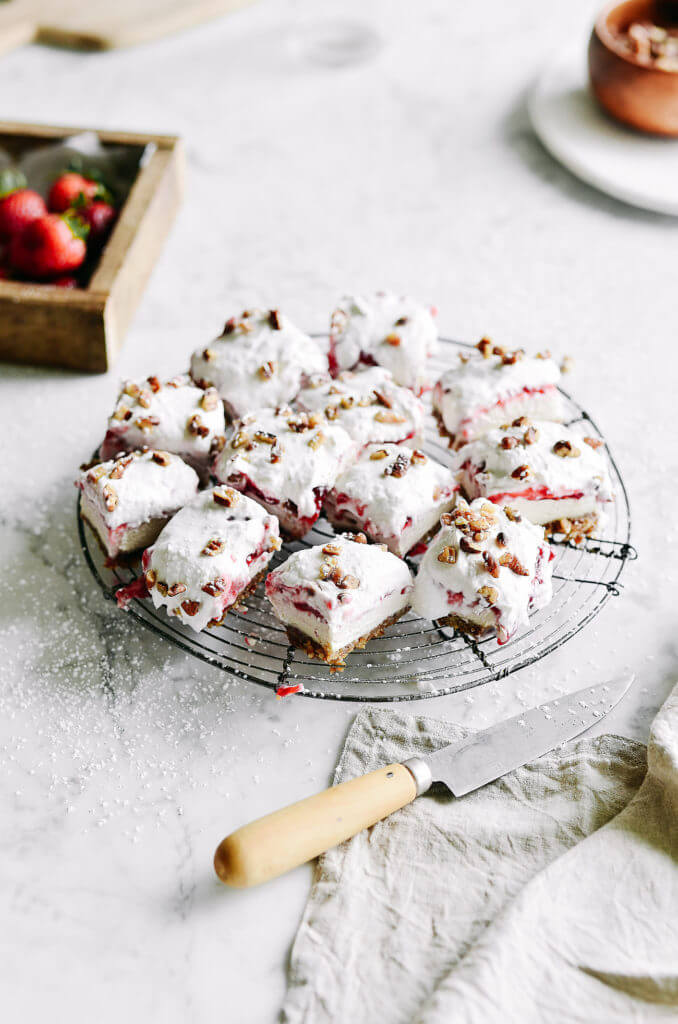 Ready in 10 minutes! Dairy free, raw, paleo cream bars, layered with a 2 ingredient crust, cashew cream cheese, raspberry filling, and whipped cream. Super easy to make in the blender and have 9g protein per square! Raw paleo cheesecake recipe. No bake cashew cheesecake. Best gluten free vegan cheesecake. Raw paleo cheesecake recipe. No bake cheesecake recipe. Paleo cream cheese. Best paleo dessert recipes. Mothers day dessert recipes. Healthy paleo meals.