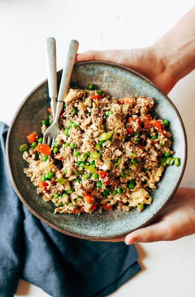 Easy 10 minute fried cauliflower rice- whole30 and paleo! Make ahead and freeze! A healthy and fun family dinner. Topped with a homemade date sweetened gooey silky smooth “soy sauce”, green onions, and sesame seeds. whole30 meal plan. Easy whole30 dinner recipes. Easy whole30 dinner recipes. Whole30 recipes. Whole30 lunch. Whole30 meal planning. Whole30 meal prep. Healthy paleo meals. Healthy Whole30 recipes. Easy Whole30 recipes. Easy whole30 dinner recipes. Best whole30 dinner recipes. Best cauliflower fried rice recipe. Easy fried rice. Best fried rice. Healthy paleo dinner recipe. Easy paleo meal ideas.