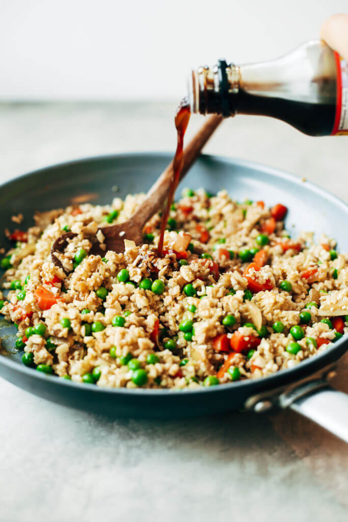 Easy 10 minute fried cauliflower rice- whole30 and paleo! Make ahead and freeze! A healthy and fun family dinner. Topped with a homemade date sweetened gooey silky smooth “soy sauce”, green onions, and sesame seeds. whole30 meal plan. Easy whole30 dinner recipes. Easy whole30 dinner recipes. Whole30 recipes. Whole30 lunch. Whole30 meal planning. Whole30 meal prep. Healthy paleo meals. Healthy Whole30 recipes. Easy Whole30 recipes. Easy whole30 dinner recipes. Best whole30 dinner recipes. Best cauliflower fried rice recipe. Easy fried rice. Best fried rice. Healthy paleo dinner recipe. Easy paleo meal ideas.