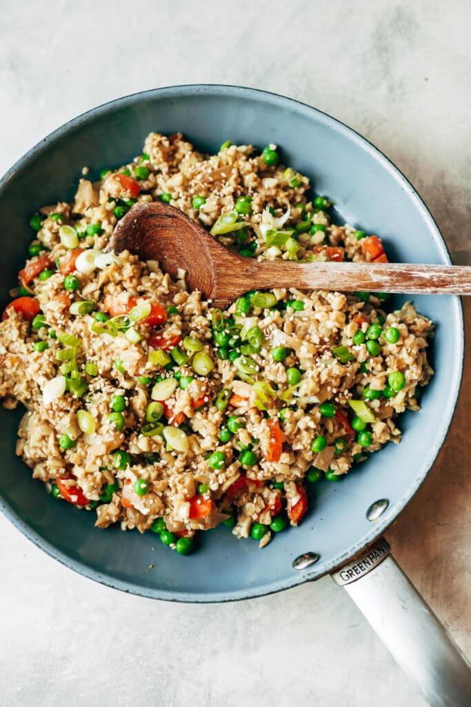 Easy 10 minute fried cauliflower rice- whole30 and paleo! Make ahead and freeze! A healthy and fun family dinner. Topped with a homemade date sweetened gooey silky smooth “soy sauce”, green onions, and sesame seeds. whole30 meal plan. Easy whole30 dinner recipes. Easy whole30 dinner recipes. Whole30 recipes. Whole30 lunch. Whole30 meal planning. Whole30 meal prep. Healthy paleo meals. Healthy Whole30 recipes. Easy Whole30 recipes. Easy whole30 dinner recipes. Best whole30 dinner recipes. Best cauliflower fried rice recipe. Easy fried rice. Best fried rice. Healthy paleo dinner recipe. Easy paleo meal ideas.