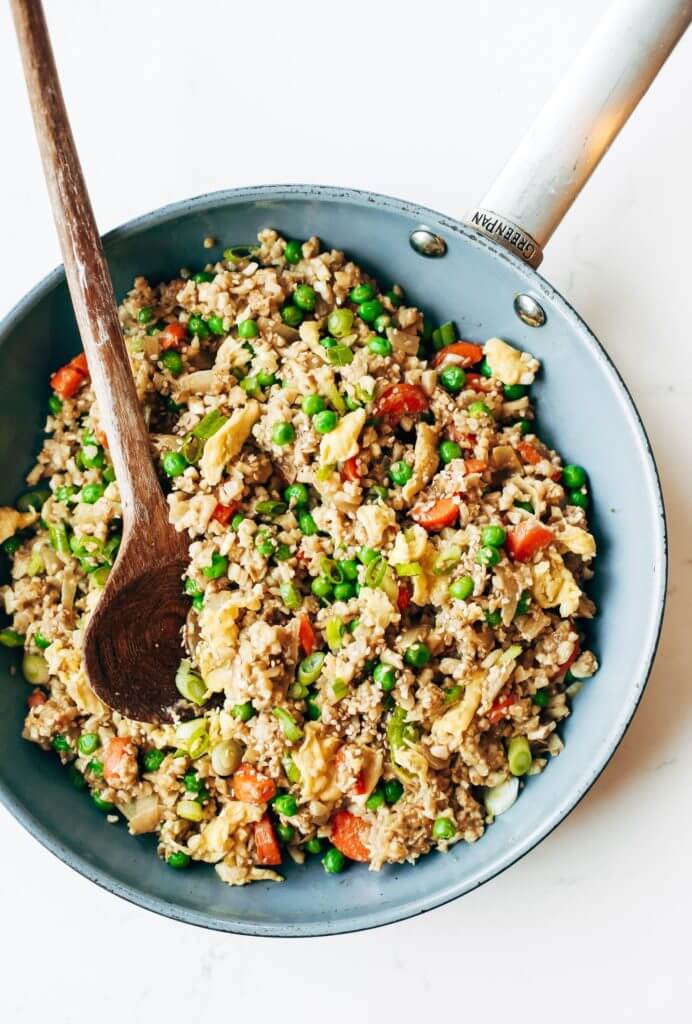 Easy 10 minute fried cauliflower rice- whole30 and paleo! Make ahead and freeze! A healthy and fun family dinner. Topped with a homemade date sweetened gooey silky smooth “soy sauce”, green onions, and sesame seeds. whole30 meal plan. Easy whole30 dinner recipes. Easy whole30 dinner recipes. Whole30 recipes. Whole30 lunch. Whole30 meal planning. Whole30 meal prep. Healthy paleo meals. Healthy Whole30 recipes. Easy Whole30 recipes. Easy whole30 dinner recipes. Best whole30 dinner recipes. Best cauliflower fried rice recipe. Easy fried rice. Best fried rice. Healthy paleo dinner recipe. Easy paleo meal ideas.