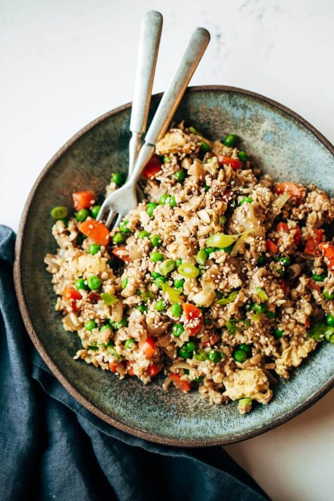 Easy 10 minute fried cauliflower rice- whole30 and paleo! Make ahead and freeze! A healthy and fun family dinner. Topped with a homemade date sweetened gooey silky smooth “soy sauce”, green onions, and sesame seeds. whole30 meal plan. Easy whole30 dinner recipes. Easy whole30 dinner recipes. Whole30 recipes. Whole30 lunch. Whole30 meal planning. Whole30 meal prep. Healthy paleo meals. Healthy Whole30 recipes. Easy Whole30 recipes. Easy whole30 dinner recipes. Best whole30 dinner recipes. Best cauliflower fried rice recipe. Easy fried rice. Best fried rice. Healthy paleo dinner recipe. Easy paleo meal ideas.