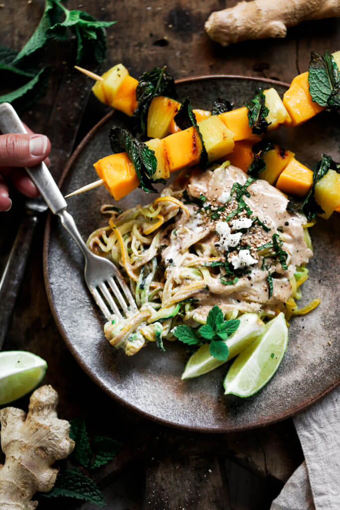 Low carb whole30 sesame ginger zucchini noodles with grilled pineapple, mango, and mint! Fresh, healthy, and low calorie dinner recipe loaded with healthy fats and my new favorite creamy sesame ginger sauce.whole30 meal plan. Easy whole30 dinner recipes. Easy whole30 dinner recipes. Whole30 recipes. Whole30 lunch. Whole30 meal planning. Whole30 meal prep. Healthy paleo meals. Healthy Whole30 recipes. Easy Whole30 recipes. Easy whole30 dinner recipes. Zucchini noodle recipe. Best veggie noodle recipes. paleo dinner recipes. best asian noodles. easy asian noodles.