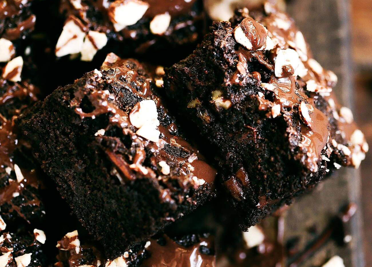 A must make decadent triple fudge coconut flour brownie recipe! Paleo and a healthy treat for everyone! Gluten eaters and healthy eaters alike will devour these rich chocolaty treats. Packed with loads of chocolate and nuts, these brownies are ready for the oven in only five minutes! Best gluten free brownies. Best paleo brownies recipe. Fudgey paleo brownie recipe. Fudgey chocolate brownies. Healthy brownie recipe. Easy paleo brownies.