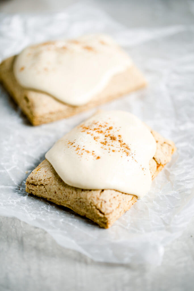 Homemade paleo pop tarts SO healthy, you can eat them for breakfast! Sweet smooth pumpkin butter filling, flakey paleo pastry, topped with the best maple cashew glaze! Clean eating pop tarts. Healthy pop tarts. Homemade gluten free pop tarts. Low carb gluten free pop tarts. Easy paleo pop tarts.