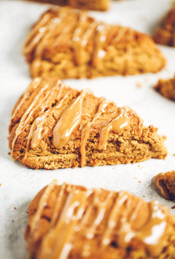 Easy gluten free, paleo pumpkin spice scones with maple glaze. A warm and comforting grain free treat for cosy fall mornings. This grain free pumpkin scone recipe is a family favorite. If you love scones as much as I do, then today is gonna be a good day for you! Easy gluten free scones Gluten free pumpkin scones. Paleo pumpkin scones. Paleo vegan pumpkin scones. Easy paleo pumpkin scones. Starbucks copy cat pumpkin scones. Healthy gluten free scones.