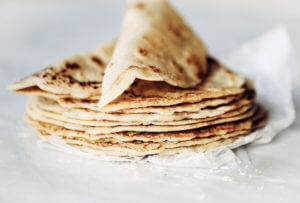 Thin soft shell paleo tortillas made in five minutes! No rolling out required. Make these soft gluten free blender by blending almond flour, tapioca flour, avocado oil, and coconut milk in a blender. Pour batter onto a skillet and out comes the most beautiful and tasty grain free tortillas, perfect for taco night or a breakfast burrito! The easiest, most versatile, fool proof, and delicious paleo flour tortillas! Easy gluten free tortilla recipe. best gluten free tortilla recipe. Best paleo tortilla recipe. Easy paleo tortillas. Healthy tortillas.