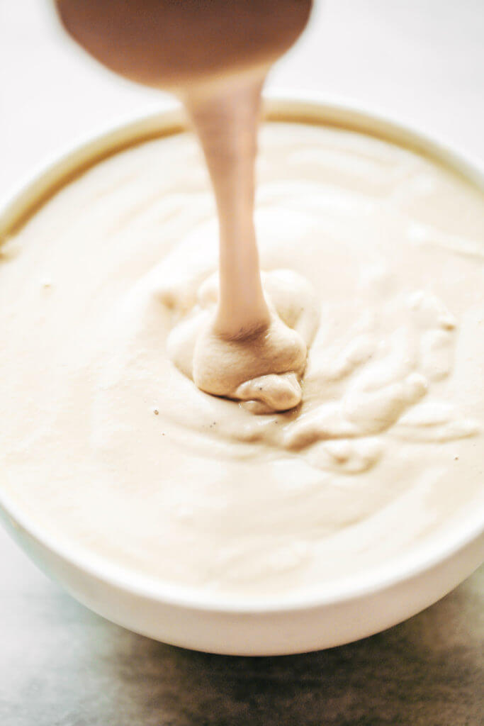 Creamy 5 minute vegan cashew cheese sauce! Whole30, paleo, and dairy free. Whipped smooth, made with raw cashews, and tastes like the perfect cheese dip for vegetables, chips, served over noodles, or licked straight off the spoon! Dairy free cheese. Dairy free Alfredo. Easy Cashew cheese. Homemade cashew cheese. easy vegan paleo cheese recipe. Best Dairy free cashew cheese recipe.