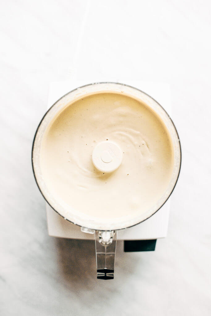 Creamy 5 minute vegan cashew cheese sauce! Whole30, paleo, and dairy free. Whipped smooth, made with raw cashews, and tastes like the perfect cheese dip for vegetables, chips, served over noodles, or licked straight off the spoon! Dairy free cheese. Dairy free Alfredo. Easy Cashew cheese. Homemade cashew cheese. easy vegan paleo cheese recipe. Best Dairy free cashew cheese recipe.