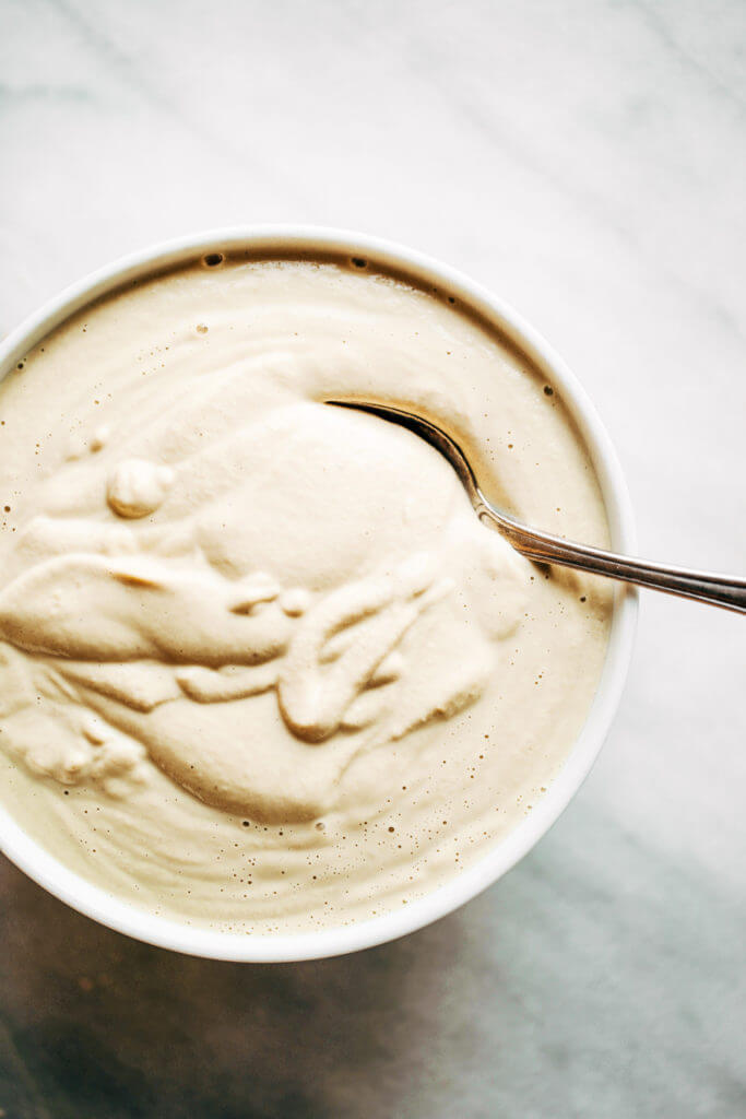 Creamy 5 minute vegan cashew cheese sauce! Whole30, paleo, and dairy free. Whipped smooth, made with raw cashews, and tastes like the perfect cheese dip for vegetables, chips, served over noodles, or licked straight off the spoon! Dairy free cheese. Dairy free Alfredo. Easy Cashew cheese. Homemade cashew cheese. easy vegan paleo cheese recipe. Best Dairy free cashew cheese recipe.