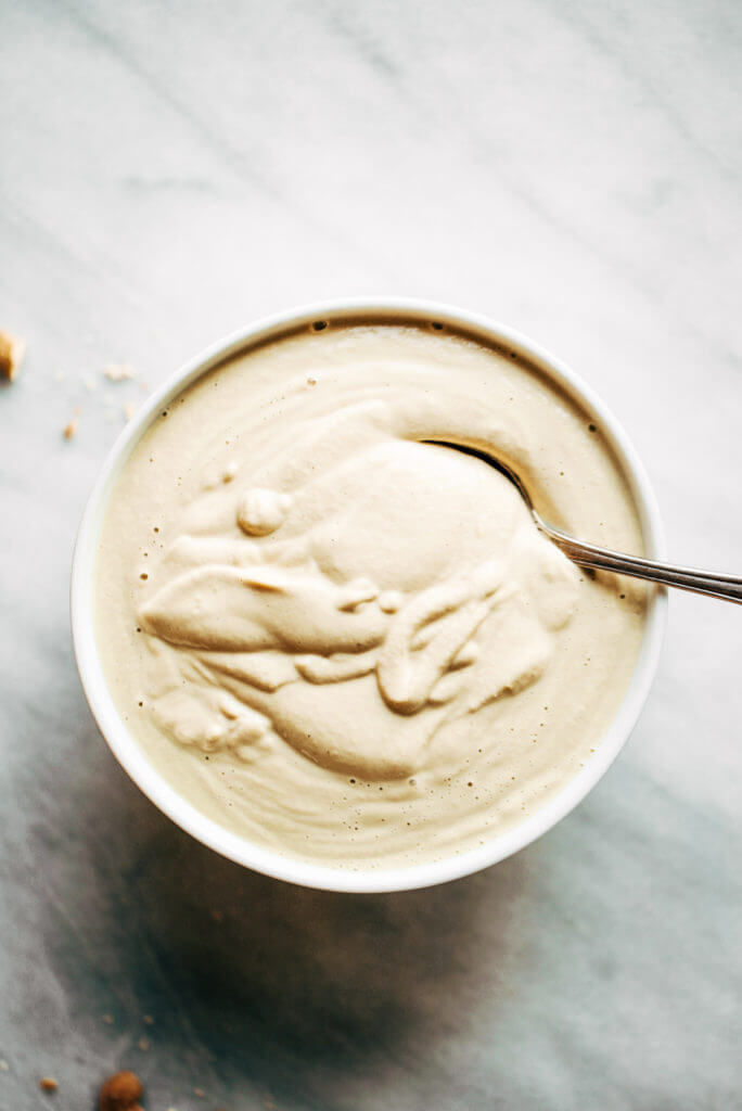 Creamy 5 minute vegan cashew cheese sauce! Whole30, paleo, and dairy free. Whipped smooth, made with raw cashews, and tastes like the perfect cheese dip for vegetables, chips, served over noodles, or licked straight off the spoon! Dairy free cheese. Dairy free Alfredo. Easy Cashew cheese. Homemade cashew cheese. easy vegan paleo cheese recipe. Best Dairy free cashew cheese recipe.