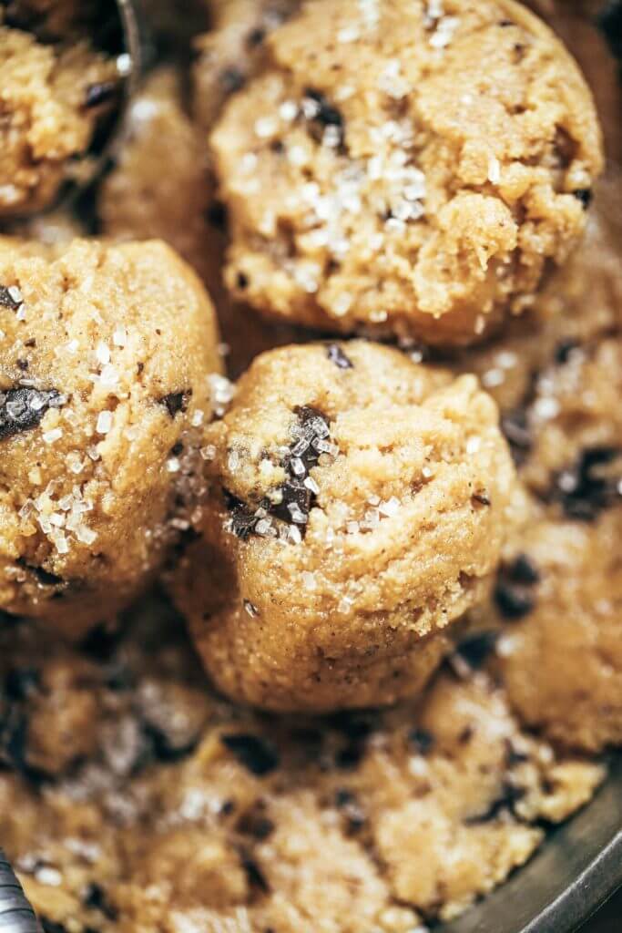 Healthy paleo cookie dough that's safe to eat raw! This cookie dough is gluten free, dairy free, and made without refined sugars. Ready in just five minutes! Paleo cookies no egg. Easy paleo cookie recipes. No bake paleo cookies. Healthy paleo cookies. Easy paleo snacks for on the go. Almond paleo cookies. best paleo cookie dough.