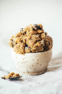 Healthy paleo cookie dough that's safe to eat raw! This cookie dough is gluten free, dairy free, and made without refined sugars. Ready in just five minutes! Paleo cookies no egg. Easy paleo cookie recipes. No bake paleo cookies. Healthy paleo cookies. Easy paleo snacks for on the go. Almond paleo cookies. best paleo cookie dough.