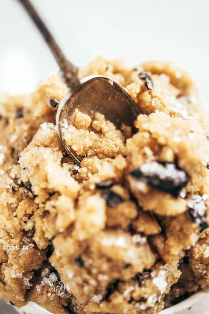 Healthy paleo cookie dough that's safe to eat raw! This cookie dough is gluten free, dairy free, and made without refined sugars. Ready in just five minutes! Paleo cookies no egg. Easy paleo cookie recipes. No bake paleo cookies. Healthy paleo cookies. Easy paleo snacks for on the go. Almond paleo cookies. best paleo cookie dough.