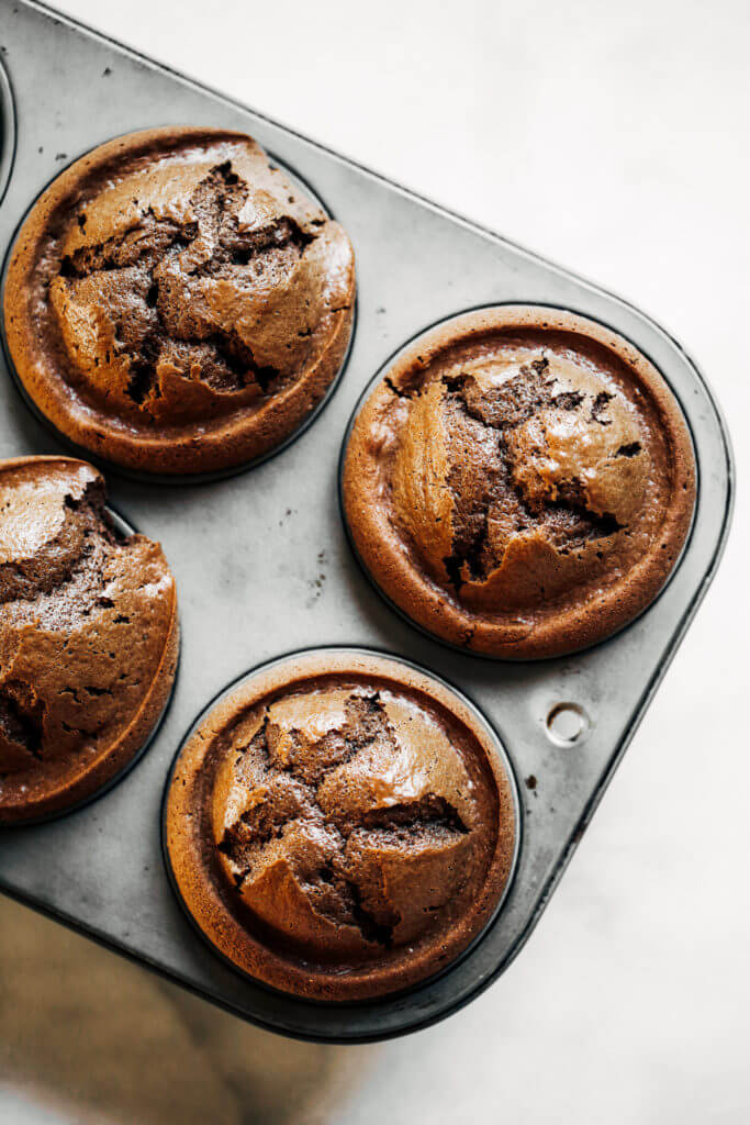 Fluffy paleo chocolate cupcakes made in the blender in 5 minutes! These chocolate cupcakes are made with healthy ingredients, avocado buttercream, and natural sprinkles! #paleo #chocolate #cupcakes #healthydessert #glutenfree #cake Paleo chocolate cupcakes recipes. Chocolate cupcakes from scratch.