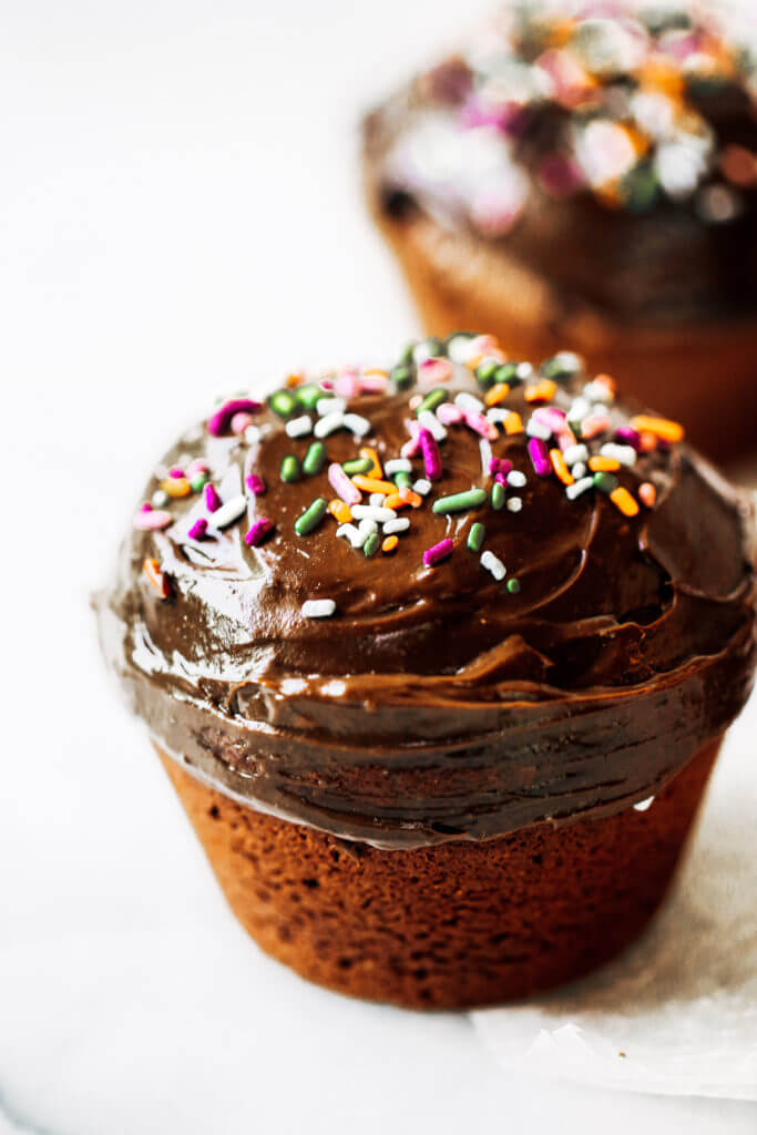 Fluffy paleo chocolate cupcakes made in the blender in 5 minutes! These chocolate cupcakes are made with healthy ingredients, avocado buttercream, and natural sprinkles! #paleo #chocolate #cupcakes #healthydessert #glutenfree #cake Paleo chocolate cupcakes recipes. Chocolate cupcakes from scratch.