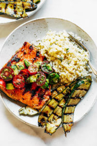 Fast Whole30 Lemony thyme grilled salmon with cauliflower rice and grilled zucchini. A healthy, light, and fresh whole30 dinner idea! An easy paleo meal for the whole family. Paleo dinner and lunch recipes. Easy paleo diet recipes. Whole30 lunch salad. Whole30 dinner recipes. Whole30 meal prep and sides. Best healthy summer dinner recipes. Grilled salmon recipes.