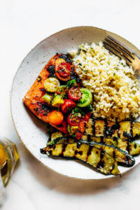 Lemony thyme grilled salmon with cauliflower rice and grilled zucchini. A healthy, light, and fresh whole30 dinner idea! An easy paleo meal for the whole family. Paleo dinner and lunch recipes. Easy paleo diet recipes. Whole30 lunch salad. Whole30 dinner recipes. Whole30 meal prep and sides. Best healthy summer dinner recipes. Grilled salmon recipes.