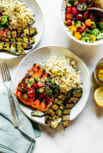 Lemony thyme grilled salmon with cauliflower rice and grilled zucchini. A healthy, light, and fresh whole30 dinner idea! An easy paleo meal for the whole family. Paleo dinner and lunch recipes. Easy paleo diet recipes. Whole30 lunch salad. Whole30 dinner recipes. Whole30 meal prep and sides. Best healthy summer dinner recipes. Grilled salmon recipes.