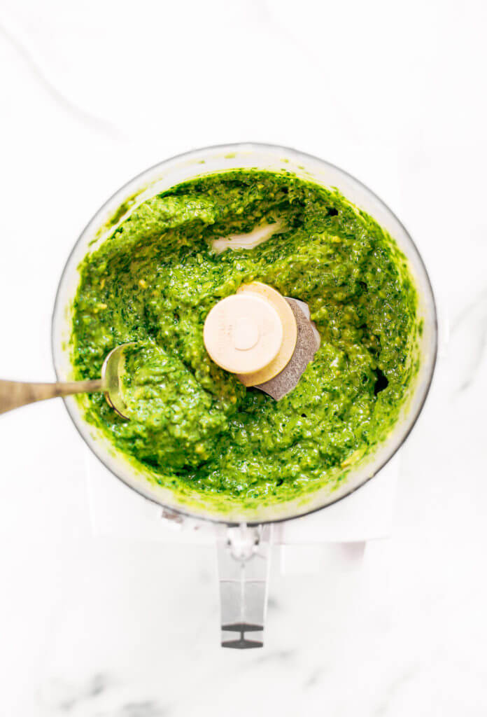 5 minute vegan kale pesto made with avocado, olive oil, and garlic. An easy paleo whole30 sauce to serve with pasta, veggie sticks, or eat with a spoon! A healthy, light, and fresh sauce. Easy whole30 pesto. paleo pesto recipe. Dairy free pesto. Best dairy free pesto recipe. Best whole30 pesto recipe.