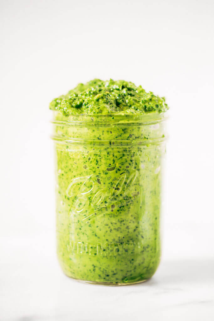 5 minute vegan kale pesto made with avocado, olive oil, and garlic. An easy paleo whole30 sauce to serve with pasta, veggie sticks, or eat with a spoon! A healthy, light, and fresh sauce. Easy whole30 pesto. paleo pesto recipe. Dairy free pesto. Best dairy free pesto recipe. Best whole30 pesto recipe.