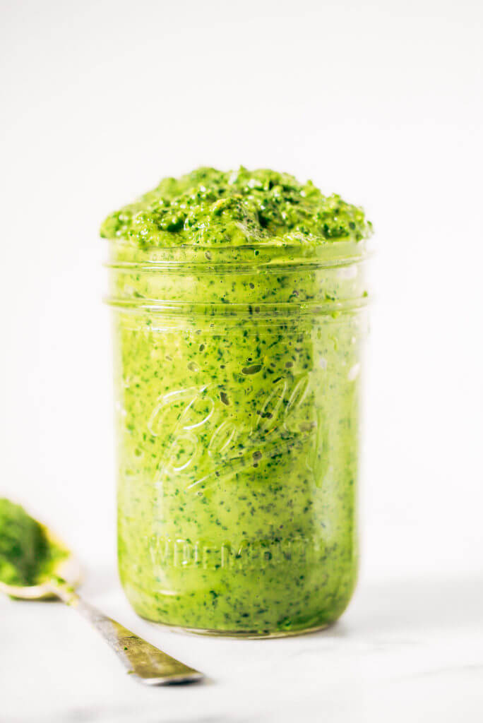 5 minute vegan kale pesto made with avocado, olive oil, and garlic. An easy paleo whole30 sauce to serve with pasta, veggie sticks, or eat with a spoon! A healthy, light, and fresh sauce. Easy whole30 pesto. paleo pesto recipe. Dairy free pesto. Best dairy free pesto recipe. Best whole30 pesto recipe.