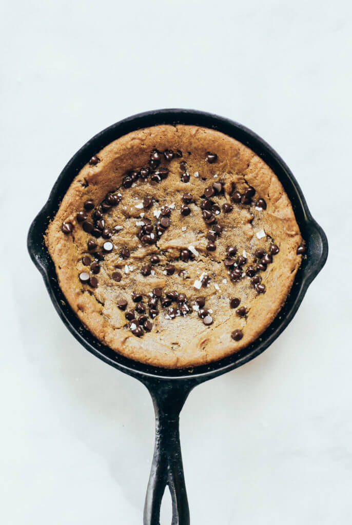 Paleo cookie skillet made in 5 minutes in the food processor. Gluten free chocolate chip cookie with a gooey inside and nice crust. Easy to make paleo dessert to share with friends! #paleo #cookie #healthydessert Easy paleo cookie recipes. Healthy paleo cookies. Easy gluten free cookie recipes. Best paleo cookie recipes. Best easy gluten free cookies.