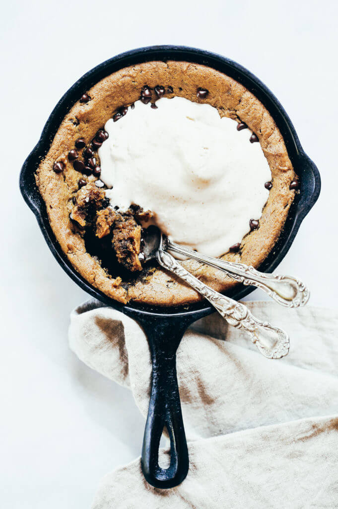 Paleo cookie skillet made in 5 minutes in the food processor. Gluten free chocolate chip cookie with a gooey inside and nice crust. Easy to make paleo dessert to share with friends! #paleo #cookie #healthydessert Easy paleo cookie recipes. Healthy paleo cookies. Easy gluten free cookie recipes. Best paleo cookie recipes. Best easy gluten free cookies.