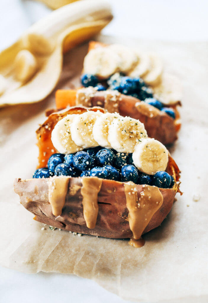 Baked sweet potatoes stuffed with blueberries, bananas, and cashew butter make a tasty whole30 vegan breakfast! You can make them ahead of time for whole30 meal prep. This easy paleo breakfast makes a great snack anytime of day! #paleo #mealprep #whole30 #vegan