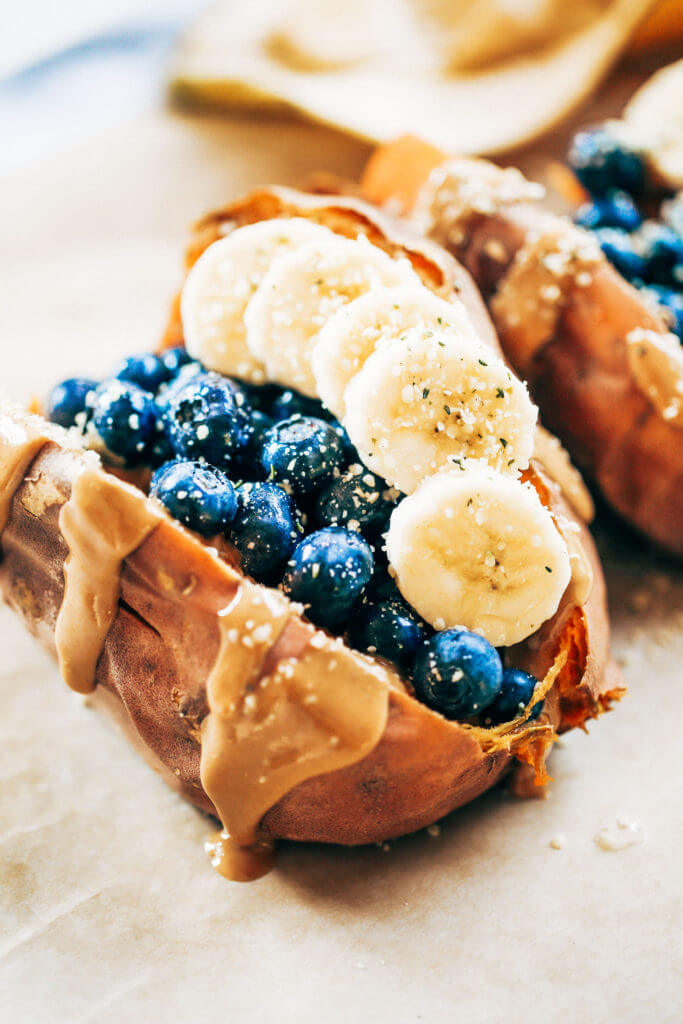 Baked sweet potatoes stuffed with blueberries, bananas, and cashew butter make a tasty whole30 vegan breakfast! You can make them ahead of time for whole30 meal prep. This easy paleo breakfast makes a great snack anytime of day! #paleo #mealprep #whole30 #vegan
