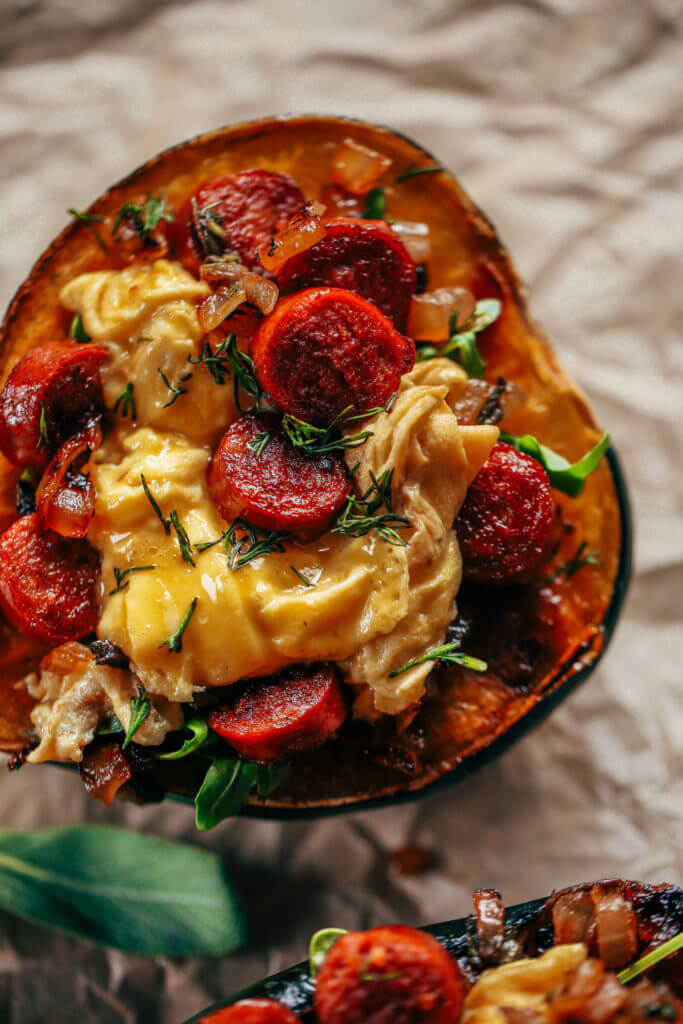 Whole30 breakfast stuffed acorn squash makes a great breakfast, lunch or dinner! Soft scrambled eggs, crispy sausage, sage, and onions all stuffed in a roasted acorn squash makes for easy paleo breakfast meal prep. Best whole30 breakfast recipe for beginners. #whole30 #mealprep #paleo #breakfast #fall